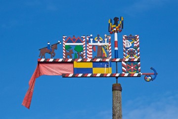 Colorful Curonian pennant flying in Nida, Lithuania - obrazy, fototapety, plakaty