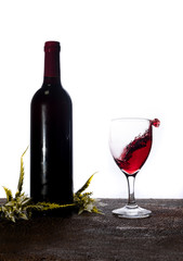Bottle of red wine on white background. Wine glasses splash