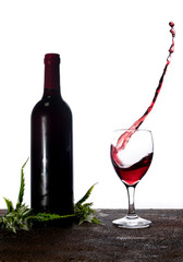 Bottle of red wine on white background. Wine glasses splash