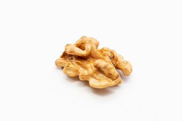One peeled walnut on a white background.