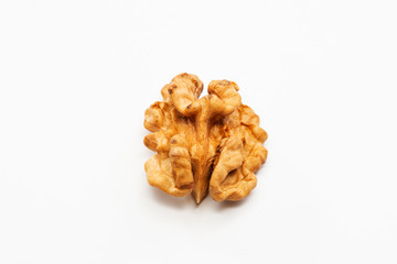 One peeled walnut on a white background.