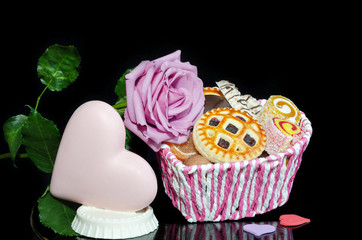 Chocolate heart, rose and cookies on Valentine's day.