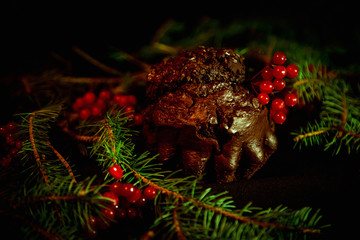 chocolate cupcake for Christmas decorated with Rowan and pine branches, with lights, handmade