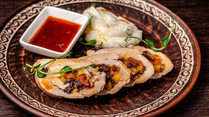 Oriental cuisine concept. Turkish dish, chicken roll with fruits and prunes, with Jerusalem artichoke puree. Top view, copy space