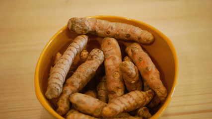 Rhizome of turmeric roots Curcuma longa in bowl, Indian saffron is cooked are dried and ground to a yellow powder. Used in curry spices anti-inflammatory effects, Pakistani and Thai cuisine