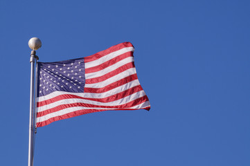 The American flag flutters in the wind. Symbol of the united state.