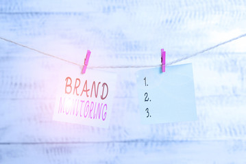 Text sign showing Brand Monitoring. Business photo showcasing process to proactively monitor the brand reputation Clothesline clothespin rectangle shaped paper reminder white wood desk