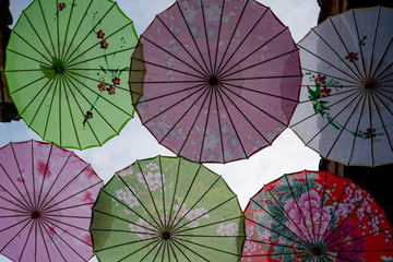 Colorful umbrellas hanging in the sky  
