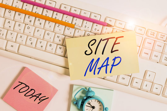 Text sign showing Site Map. Business photo showcasing designed to help both users and search engines navigate the site Flat lay above empty note paper on the pc keyboard pencils and clock