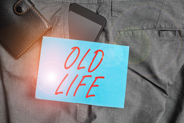 Conceptual hand writing showing Old Life. Concept meaning the way I was in the past before some important change happened Smartphone device inside trousers front pocket with wallet