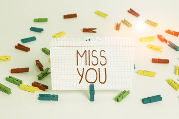 Writing note showing Miss You. Business concept for Feeling sad because you are not here anymore loving message Colored clothespin papers empty reminder white floor background office