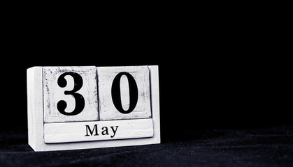 May 30th, Thirtieth of May, Day 30 of month May - vintage wooden white calendar blocks on black background with empty space for text