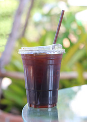 Iced americano coffee with ice on table in cafe at outdoor.