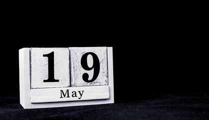 May 19th, Nineteenth of May, Day 19 of month May - vintage wooden white calendar blocks on black background with empty space for text