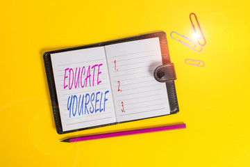 Conceptual hand writing showing Educate Yourself. Concept meaning To train or prepare oneself in a particular area or subject Dark leather locked diary striped sheets marker colored background