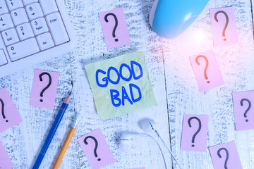 Word writing text Good Bad. Business photo showcasing to seem to be going to have a good or bad result Life choices Writing tools, computer stuff and scribbled paper on top of wooden table
