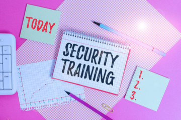 Text sign showing Security Training. Business photo showcasing providing security awareness training for end users Writing equipments and computer stuffs placed above colored plain table