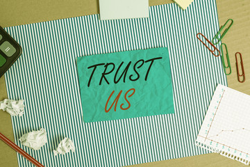 Handwriting text Trust Us. Conceptual photo to believe that someone is good and honest and will not harm Striped paperboard notebook cardboard office study supplies chart paper