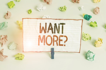Handwriting text writing Want Morequestion. Conceptual photo If you want something you feel a desire or a need for it Colored crumpled papers empty reminder white floor background clothespin