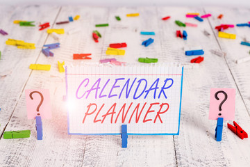 Conceptual hand writing showing Calendar Planner. Concept meaning schedule of activities or task that must be completed Crumbling sheet with paper clips placed on the wooden table