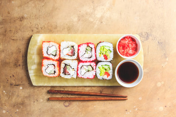 Fototapeta na wymiar japanese sushi food. Rolls with tuna, salmon, shrimp, crab and vegetables. Top view of assorted sushi. Rainbow sushi roll on stone background. Flat lay