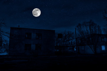 Vintage country house at night with clouds and stars. Cold autumn night