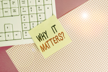 Text sign showing Why It Matters question. Business photo text ask demonstrating about something he think is important Note paper stick to computer keyboard near colored gift wrap sheet on table
