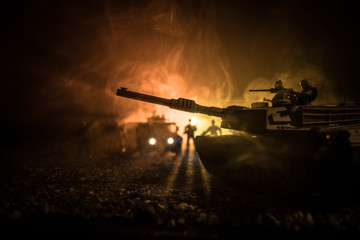 War Concept. Armored vehicle silhouette fighting scene on war foggy sky background at night....