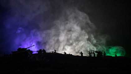 Fototapeta na wymiar War Concept. Military silhouettes fighting scene on war fog sky background, World War German Tanks Silhouettes Below Cloudy Skyline At night. Attack scene. Armored vehicles and infantry.