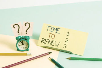 Text sign showing Time To Renew. Business photo text Continue the insurance acquired Life and property protection Mini size alarm clock beside stationary placed tilted on pastel backdrop