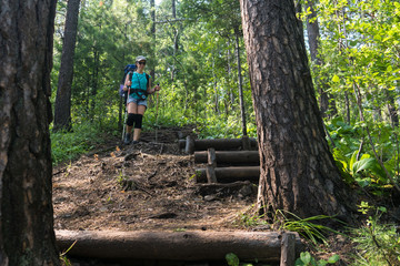 Girl tourist descends along the Great Baikal trail