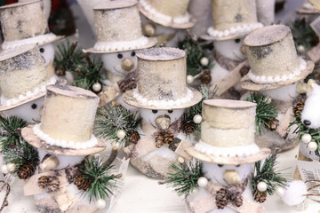 Little snowmen in hats Christmas background. Happy winter holidays.