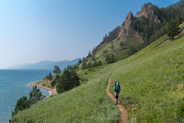 Girl tourist walks along the Great Baikal trail