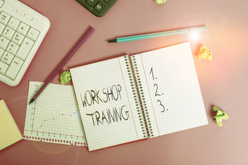 Conceptual hand writing showing Workshop Training. Concept meaning participants carry out a number of training activities Writing equipments and computer stuff placed on wooden table