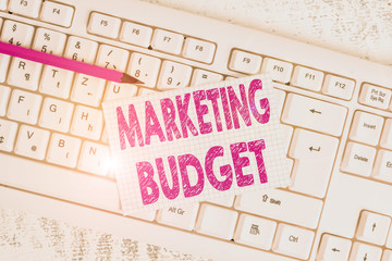 Word writing text Marketing Budget. Business photo showcasing estimated amount of cost required to promote products White keyboard office supplies empty rectangle shaped paper reminder wood