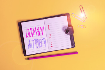 Conceptual hand writing showing Domain Authority. Concept meaning calculated metric for how well a domain is likely to rank Dark leather locked diary striped sheets marker colored background