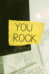 Writing note showing You Rock. Business concept for slang phrase of praise or encouragement conveying you are awesome Notation paper computer monitor screen near white keyboard