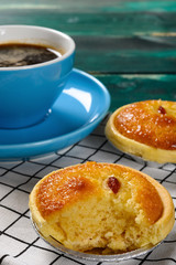 side view fresh cocknut tart with a bite and cup of coffee on back vertical composition