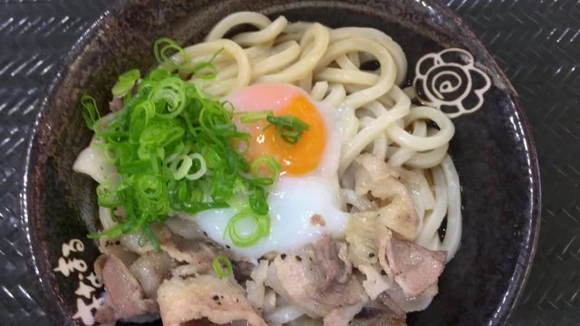 Japanese Food. Chopsticks Taking Pork Out Of Bowl Of Bukkake Udon Noodles