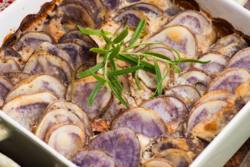 Violet potato gratin with cream and rosemary