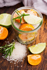 Preserved Lime and Mandarin with salt on a wooden board