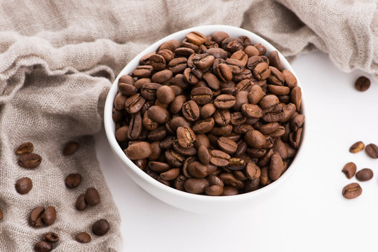 Bowl of caffee beans on a white background