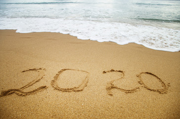 Number 2020 written in the sand