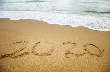 Number 2020 written in the sand