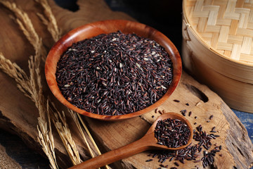 close up riceberry rice in measuring cup on table, riceberry rice in chinese kitchen background