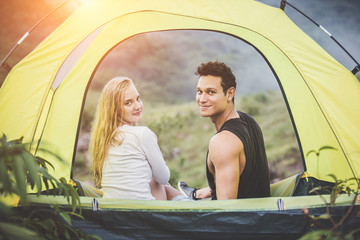 Couple camping lovers hug other with love in the tent.