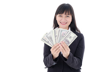 Portrait of young Asian business woman wearing a black suit be a smile and holding showing money cash fan of 100 us bills on white background, studio isolated.