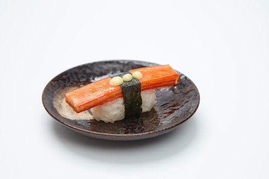 single served nigiri sushi made of kani kama isolated on white background