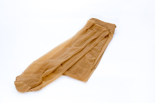 Women's nylon tights comfortable pantyhose beige tan color lingerie tights on isolated white background.