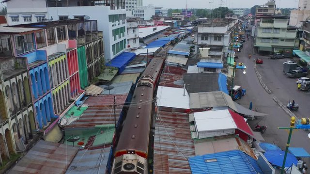 Aerial view of Rom Hoop market. Thai Railway with a local train run through Mae Klong Market in Samut Songkhram Province, Thailand. Tourist attraction in travel and transportation concept.